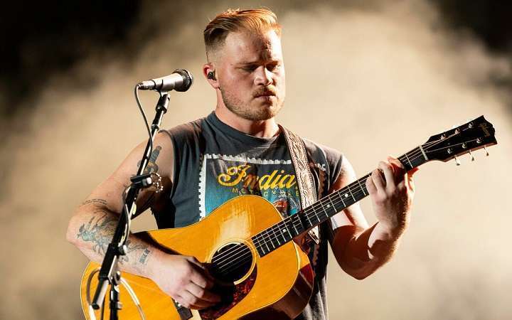 You are currently viewing Unveiling Zach Bryan’s Net Worth: Exploring the Physical Attributes of the Rising Musician, Biography, Career, Family, Physical Appearances and Social Media